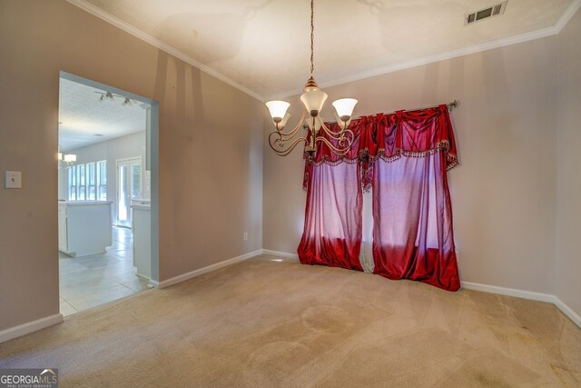 spare room with carpet and an inviting chandelier