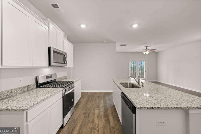 kitchen featuring sink, white cabinetry, a center island with sink, appliances with stainless steel finishes, and ceiling fan