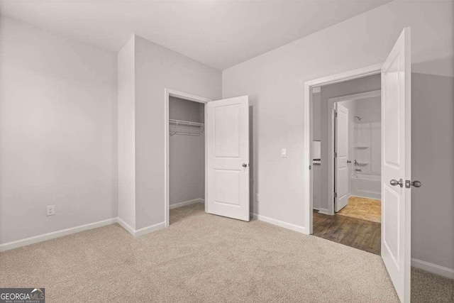 unfurnished bedroom featuring carpet floors and a closet