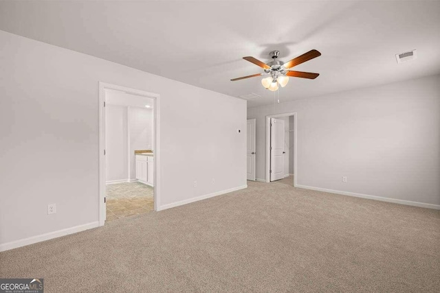 unfurnished room featuring light colored carpet and ceiling fan