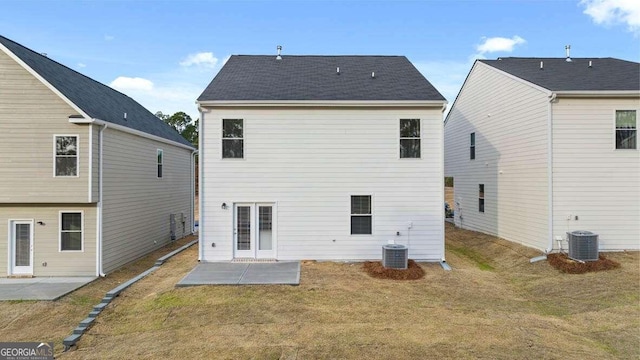 back of property with a yard, central AC unit, and a patio area