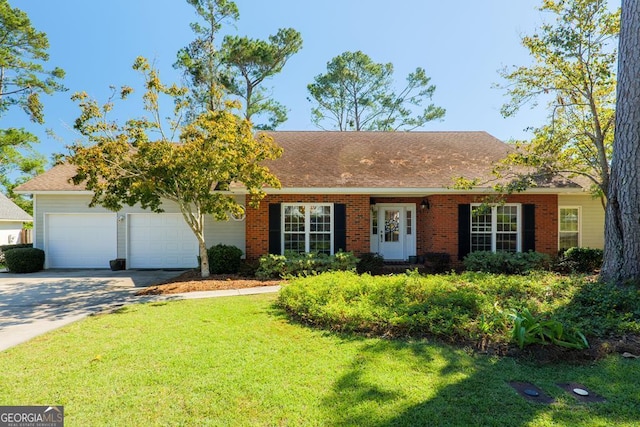 view of front of property featuring a front yard and a garage