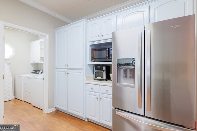 kitchen with light hardwood / wood-style flooring, independent washer and dryer, ornamental molding, white cabinets, and appliances with stainless steel finishes