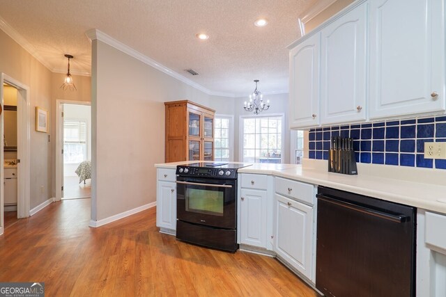 kitchen featuring decorative backsplash, black appliances, pendant lighting, white cabinetry, and a textured ceiling