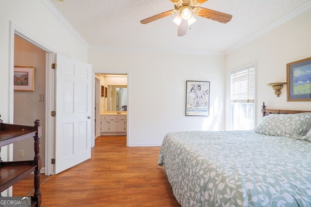 bedroom with ornamental molding, a textured ceiling, hardwood / wood-style flooring, and ceiling fan