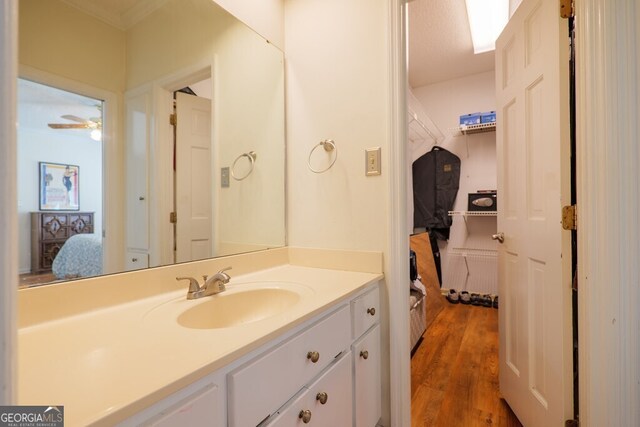 bathroom featuring vanity, hardwood / wood-style floors, a textured ceiling, and ceiling fan