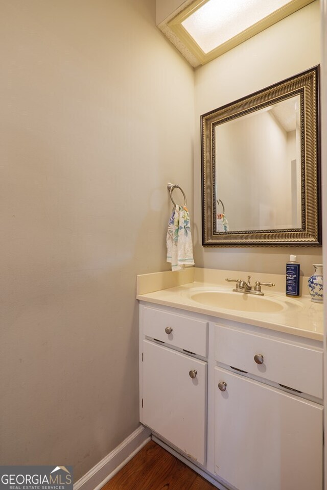 bathroom with vanity and hardwood / wood-style floors