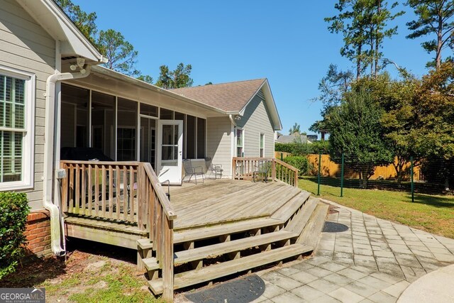 wooden deck featuring a sunroom