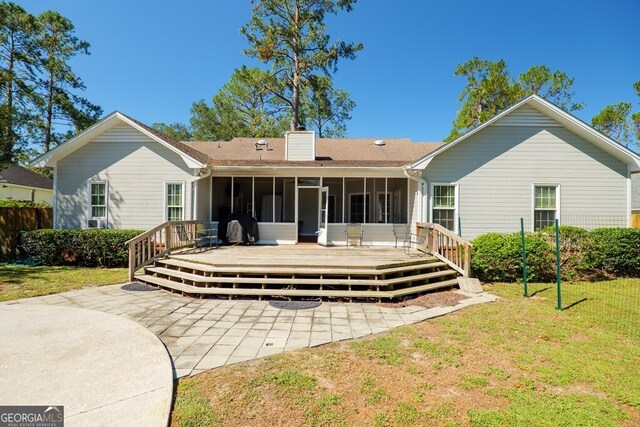 rear view of house with a yard, a deck, and a patio