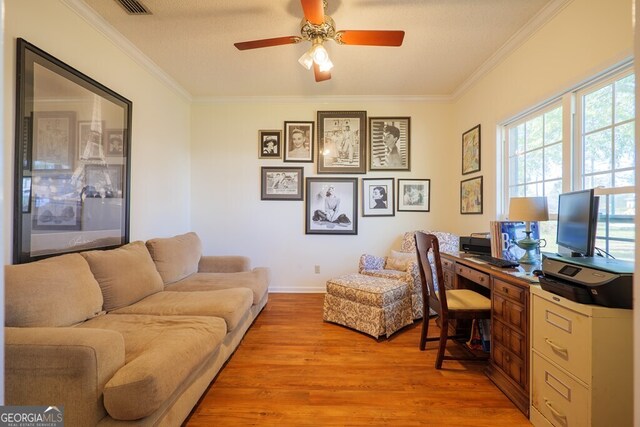 office with ornamental molding, light hardwood / wood-style flooring, a textured ceiling, and ceiling fan