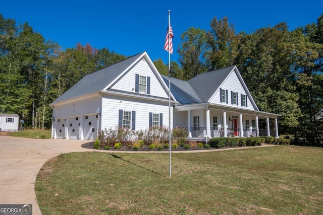 view of front of property with a porch, a front yard, and a garage