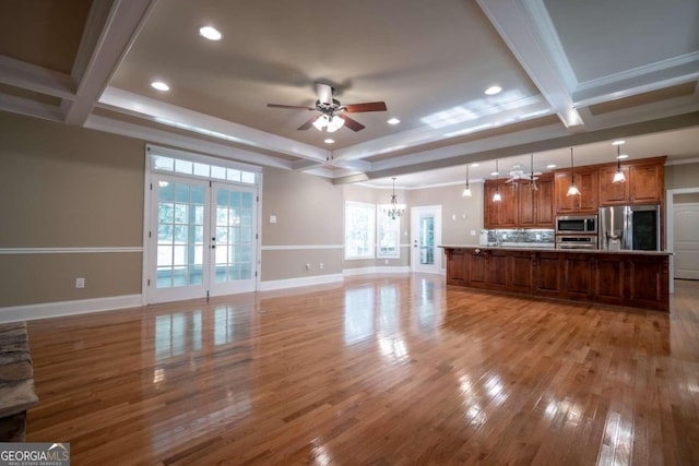 kitchen with french doors, a large island, pendant lighting, light wood-type flooring, and appliances with stainless steel finishes