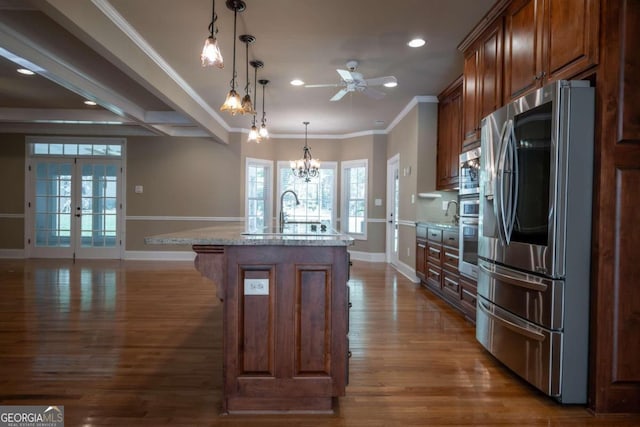 kitchen featuring crown molding, a kitchen island with sink, dark hardwood / wood-style flooring, and stainless steel refrigerator with ice dispenser