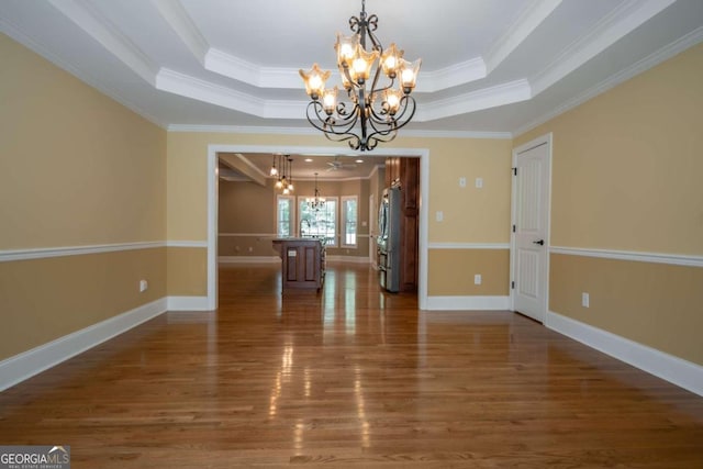 unfurnished dining area featuring crown molding, a notable chandelier, and dark hardwood / wood-style flooring