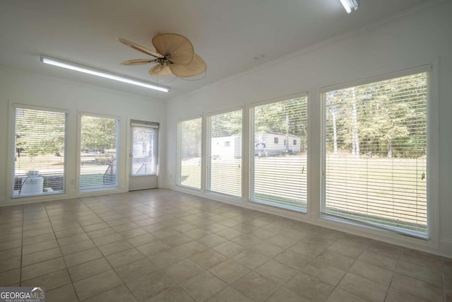 unfurnished sunroom with ceiling fan