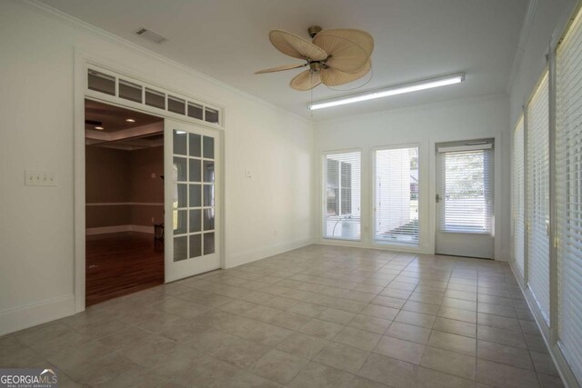 empty room featuring crown molding, ceiling fan, french doors, and light tile patterned floors