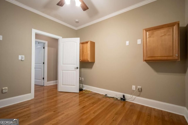 washroom featuring ornamental molding, ceiling fan, light hardwood / wood-style floors, and cabinets