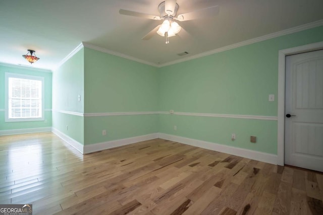 unfurnished room with ornamental molding, light wood-type flooring, and ceiling fan