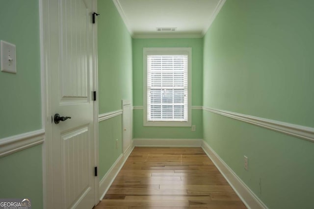 interior space with light hardwood / wood-style flooring and crown molding