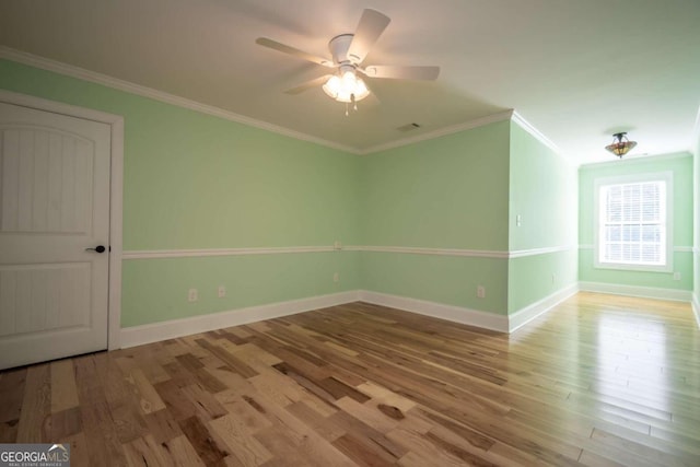 unfurnished room featuring ceiling fan, crown molding, and hardwood / wood-style floors