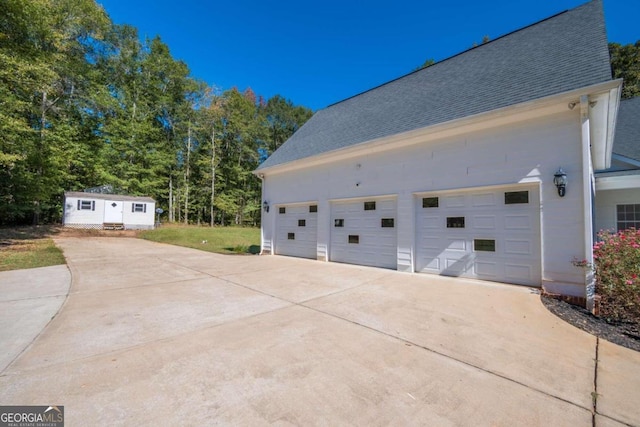 view of side of property with an outbuilding and a garage