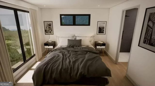 bedroom featuring multiple windows and light wood-type flooring