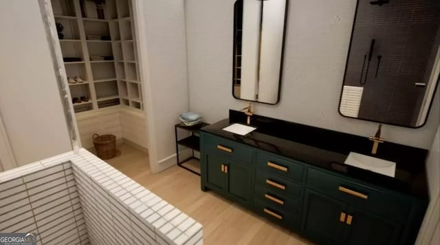 bathroom with hardwood / wood-style flooring and a shower