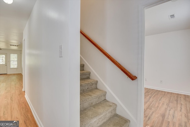 staircase featuring hardwood / wood-style flooring