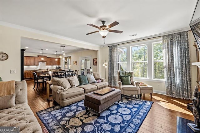 living room featuring crown molding, ceiling fan, and hardwood / wood-style floors