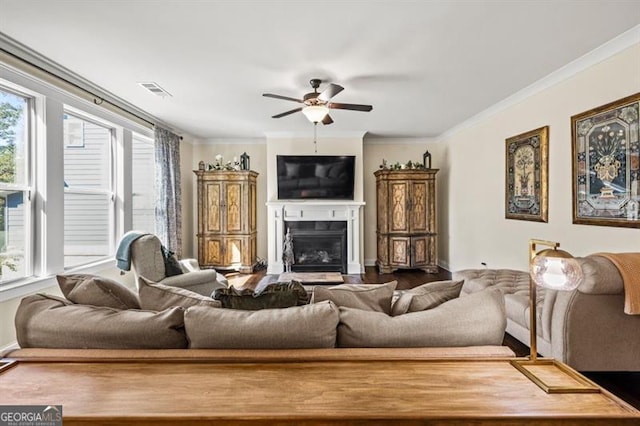 living room featuring ornamental molding and ceiling fan