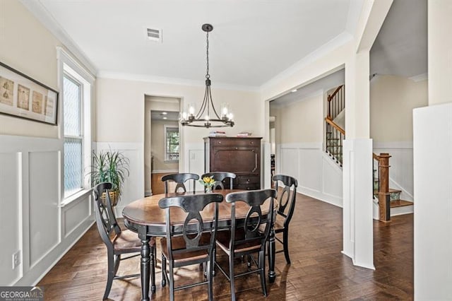 dining space with crown molding, plenty of natural light, dark hardwood / wood-style floors, and a notable chandelier