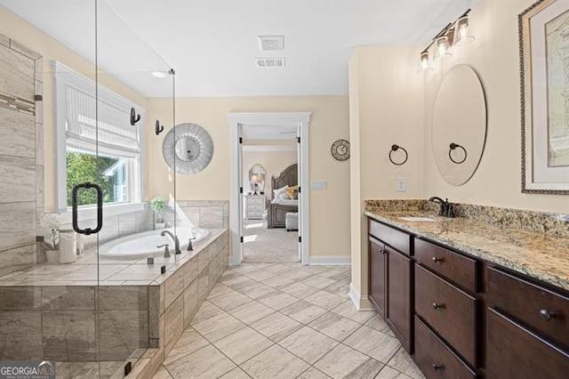 ensuite bathroom featuring ensuite bathroom, visible vents, vanity, a bath, and tile patterned floors