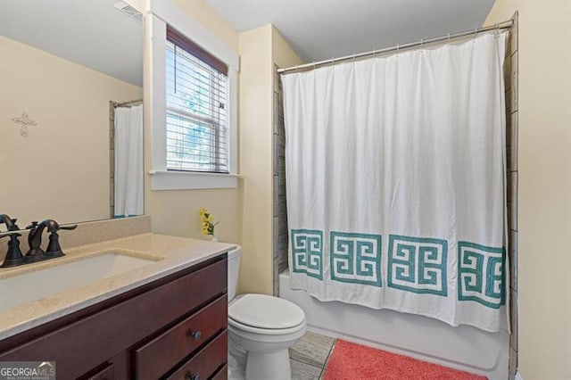 bathroom with toilet, visible vents, shower / bath combo with shower curtain, and vanity