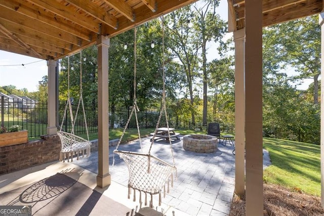 view of patio / terrace with fence and a fire pit