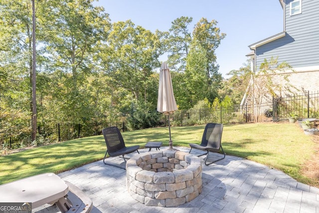 view of patio with fence and a fire pit