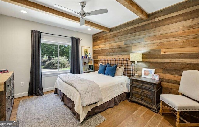 bedroom featuring beam ceiling, ceiling fan, and light wood-type flooring