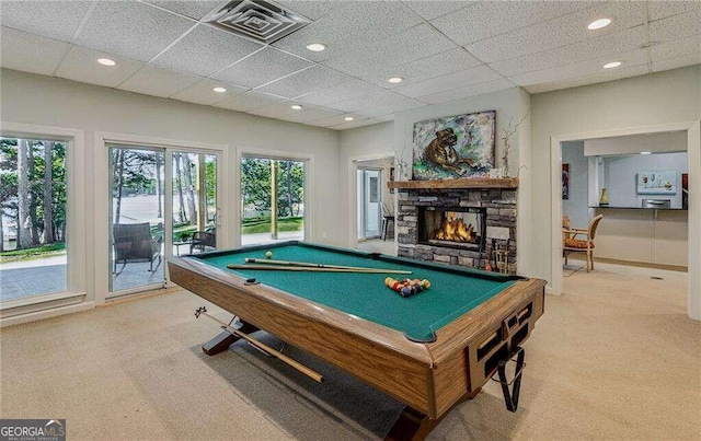 playroom featuring carpet flooring, a stone fireplace, a drop ceiling, and pool table