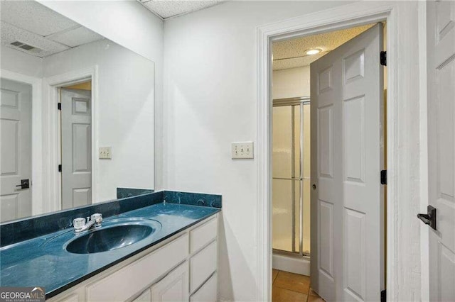 bathroom featuring vanity, tile patterned floors, and a shower with shower door