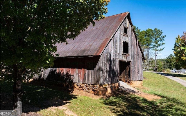 view of property exterior with an outdoor structure