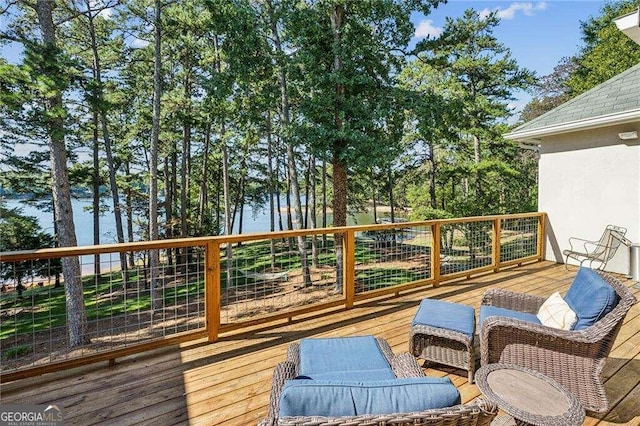 wooden terrace featuring a water view