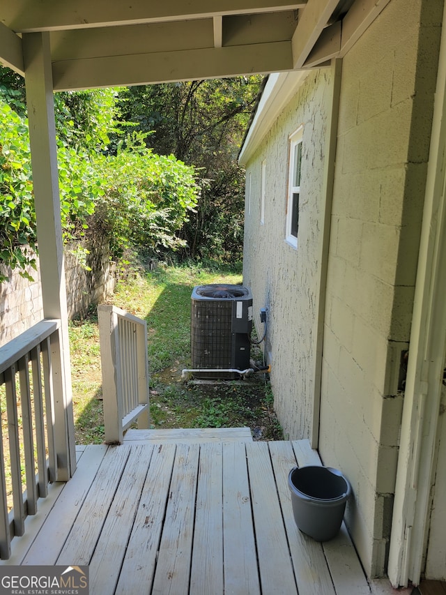 wooden deck with central air condition unit