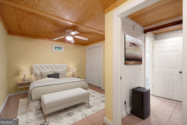 tiled bedroom featuring wood ceiling, a closet, and ceiling fan