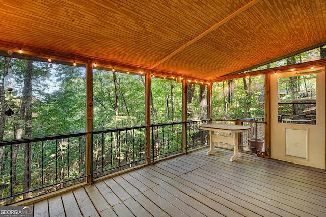 unfurnished sunroom featuring lofted ceiling