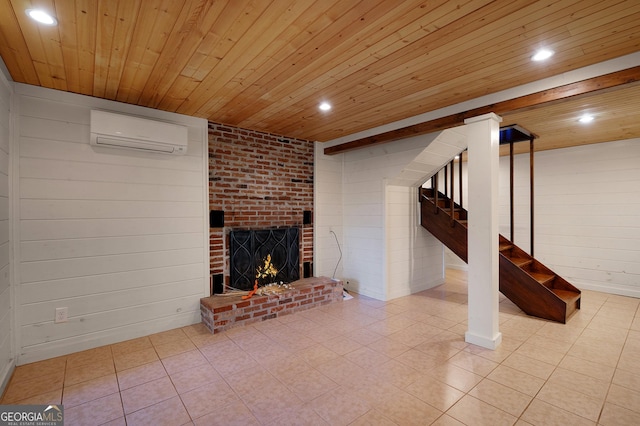 unfurnished living room with an AC wall unit, wood walls, wood ceiling, and a brick fireplace