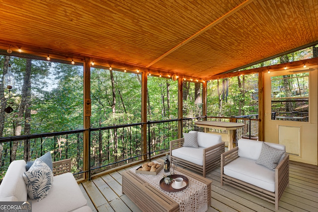 sunroom featuring lofted ceiling