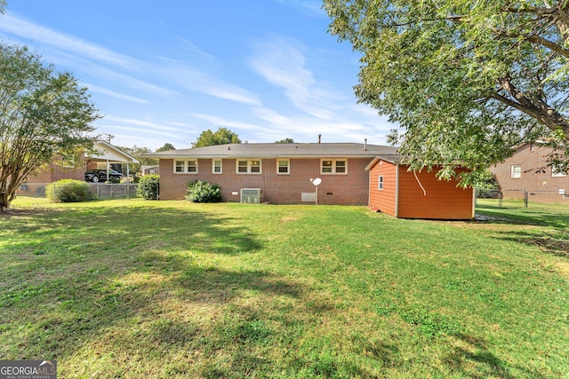 back of house featuring central AC and a lawn