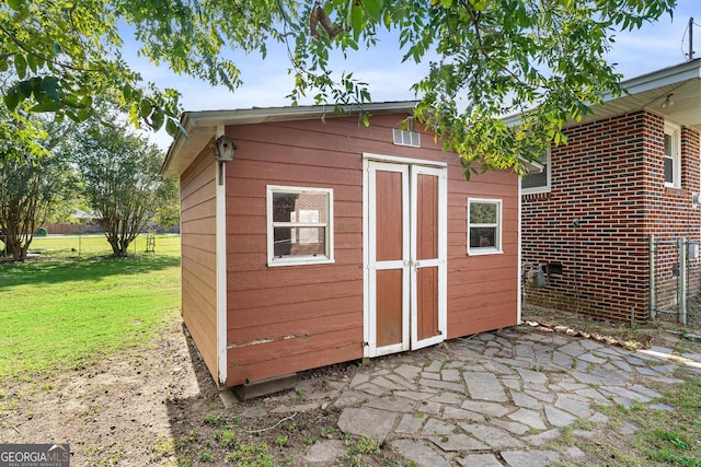 view of outdoor structure with a lawn