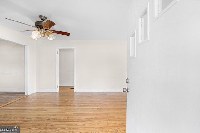 empty room featuring light wood-type flooring and ceiling fan