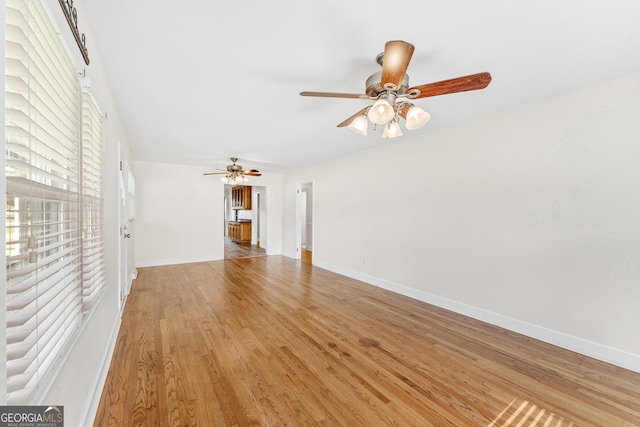 unfurnished living room with ceiling fan and light hardwood / wood-style flooring