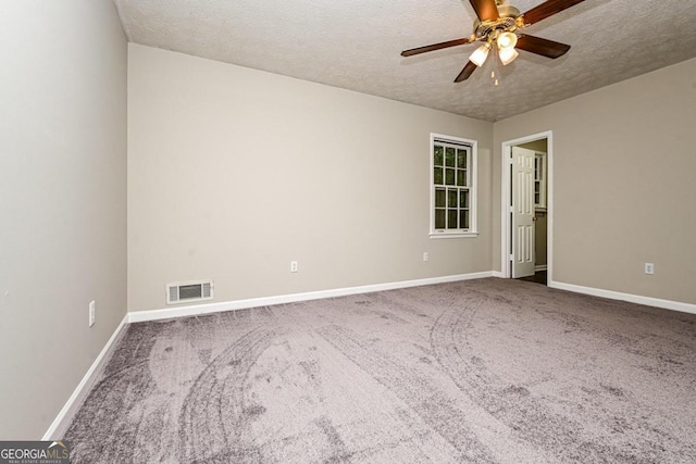 carpeted empty room featuring a textured ceiling and ceiling fan